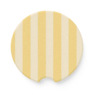 May include: Yellow and white striped round car coaster. The coaster has a cutout for a cup holder.