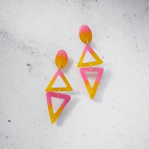 Yellow and neon pink 80s inspired geometric mirrored dangling triangle statement resin earrings