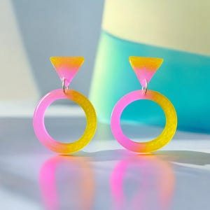Yellow and neon pink 80s inspired circular geometric statement resin dangle earrings