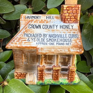 May include: A handmade wooden sign with the text "Welcome" in a playful font. The sign features a distressed white background and a dark brown frame, perfect for a front door or entryway. The sign measures approximately 12 inches wide.