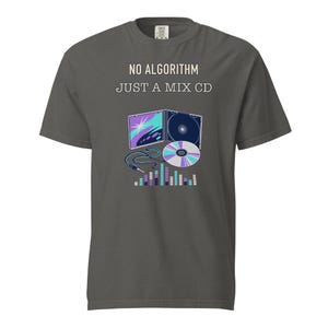 May include: A charcoal gray short-sleeve t-shirt featuring the text NO ALGORITHM JUST A MIX CD in white and beige. The graphic includes an open CD case, a loose compact disc, an audio cable, and a colorful digital sound equalizer bar display.