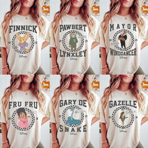 Puede incluir: Seis camisetas color crema con personajes de Disney. Cada camiseta tiene un gr&aacute;fico circular con el nombre y la imagen de un personaje. Los personajes incluyen Finnick, Pawbert Lynxley, Mayor Winddancer, Fru Fru, Gary De Snake y Gazelle.
