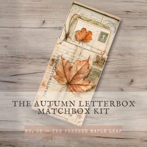 May include: A rectangular matchbox kit titled The Autumn Letterbox Matchbox Kit No. 03 The Pressed Maple Leaf. The box features a vintage-style paper cover with cursive handwriting, a postage stamp, and a large, dried, orange-brown maple leaf.