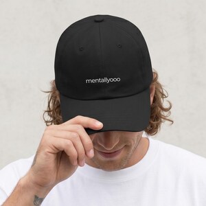 May include: Black baseball cap with the word "mentallyooo" embroidered in white. The cap is made of a soft material and has a curved brim. A classic, casual accessory.