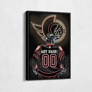 May include: A black and gold hockey jersey with a neon red number "00" and the text "ANY NAME" on the back. The jersey is worn by a hockey player with a helmet and is set against a black background with a gold and red winged logo.