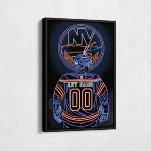 May include: A framed neon-style artwork featuring a hockey player in a blue and orange jersey with the number 00. The jersey has the text "ANY NAME" above the number. The background includes the NY Islanders logo in a circle.