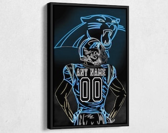 May include: A black and blue neon art print of a football player wearing a Carolina Panthers jersey with the text "ANY NAME 00". The player is standing in front of a neon blue panther head.
