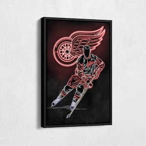 May include: A neon red and white hockey player silhouette with a red winged logo in the background. The player is holding a hockey stick and is in a skating position.