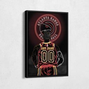 May include: A neon-style illustration of a basketball player wearing a red and yellow Atlanta Hawks jersey with the team logo and the words "Atlanta Hawks Basketball" in a circle above the player. The player's back is to the viewer and the jersey has the name "ANY NAME" and the number "00" on the back.