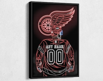 Op de afbeelding: Een neonrood en wit silhouet van een hockeyer met een rood vleugellogo en de tekst "ANY NAME 00" op het shirt.