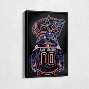 May include: Framed artwork featuring a neon-style illustration of a hockey player in a blue and red jersey with the number 00. The player is set against a black background with the team logo in the background. The jersey reads "ANY NAME".