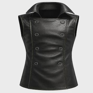 May include: A black leather vest with a double-breasted design. The vest features a notched collar and six decorative buttons down the front. The vest has a tailored fit and a smooth, matte finish.