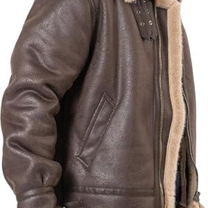 May include: A dark brown jacket with a textured finish, featuring a thick beige faux fur lining and collar. The jacket includes a front metal zipper, two side pockets, and adjustable buckle straps at the collar for a secure fit around the neck.