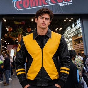 May include: A black and yellow leather jacket featuring a prominent X-shaped design on the front, a classic collar, and two horizontal yellow stripes on each sleeve. The right sleeve displays a circular yellow and black X-Men logo emblem.