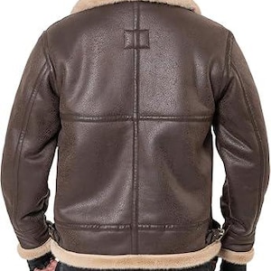 May include: A dark brown jacket with a textured finish, featuring a wide beige faux fur collar and matching faux fur trim along the hem and sleeve cuffs. The back of the jacket displays vertical and horizontal seam detailing and side buckles.
