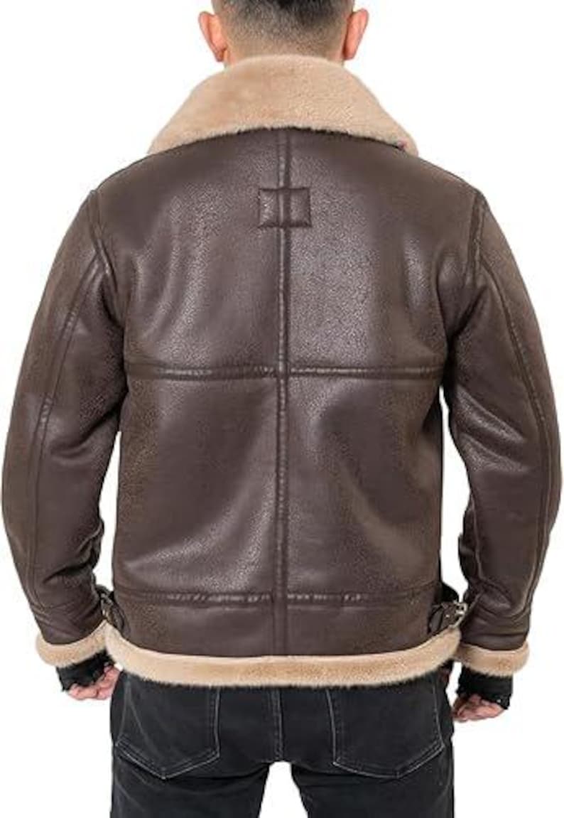 May include: A dark brown jacket with a textured finish, featuring a wide beige faux fur collar and matching faux fur trim along the hem and sleeve cuffs. The back of the jacket displays vertical and horizontal seam detailing and side buckles.