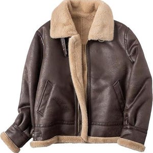 May include: A dark brown jacket with a textured finish, featuring a wide beige faux fur collar and interior lining. The jacket includes a front zipper closure, two slanted side pockets, and adjustable straps with metal buckles at the cuffs and collar.