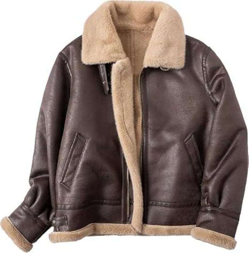 May include: A dark brown jacket with a textured finish, featuring a wide beige faux fur collar and interior lining. The jacket includes a front zipper closure, two slanted side pockets, and adjustable straps with metal buckles at the cuffs and collar.