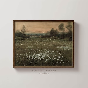 May include: A framed landscape print depicting a field of white flowers under a twilight sky. The artwork has a vintage style, with a warm colour palette and a golden-brown frame. The text "GOLDEN GARLAND studios" is at the bottom.
