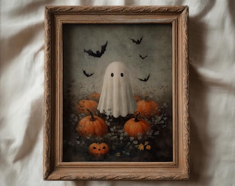 Puede incluir: Una obra de arte enmarcada con temática de Halloween. La imagen presenta un fantasma blanco entre calabazas naranjas y pequeñas flores. Murciélagos negros vuelan en el fondo. El marco es de madera marrón claro.