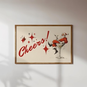 Pode incluir: Uma impressão emoldurada com uma ilustração vintage do Pai Natal num copo de Martini. A imagem inclui a palavra "Cheers!" em escrita vermelha, juntamente com estrelas, evocando um tema festivo de férias.