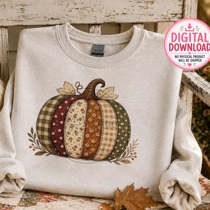 May include: A light beige crewneck sweatshirt featuring a central graphic of a pumpkin composed of vertical segments with various patterns including green plaid, red stars, floral prints, orange dots, and brown gingham, accented by small leaves.