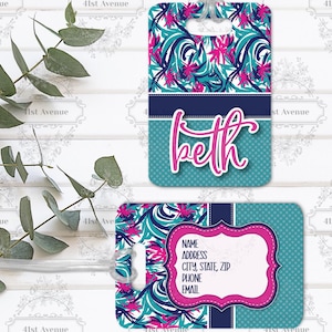 May include: Two luggage tags with a floral pattern in teal, navy, and pink. One tag has the name "Beth" in pink script. The other tag has a pink framed area for name, address, city, state, zip, phone, and email.