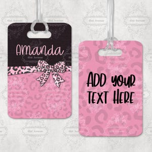 May include: Two pink luggage tags with a leopard print design. The first tag says "Amanda" and the second tag says "ADD YOUR TEXT HERE".