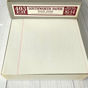 May include: A box of Southworth Paper Four Star 403ER ruled paper with a regular finish. The box label specifies 8.5 by 14 inches, 20 lb heavy weight, and 500 sheets. The paper inside is off-white with a vertical red margin line on the left.