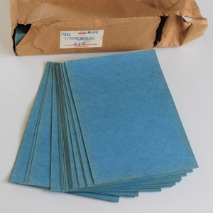 May include: A stack of 250 blue leather finish paper sheets. The package label reads "250 BLUE LEATHER FINISH 6x9 The Reliable Leather Finish Co."