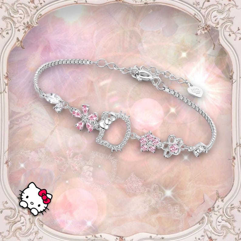 May include: A silver bracelet with a Hello Kitty charm and pink crystal accents. The bracelet features a flower, star, and Hello Kitty charm.