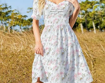 May include: A white floral print dress with a sweetheart neckline and short, puffed sleeves. The dress features a gathered bodice and a flowing skirt, with pink and green floral patterns. The dress is knee-length and suitable for warm weather.