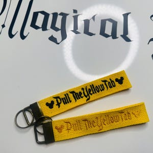 Pull the Yellow Tab keychain: Disney park’s inspired keychain