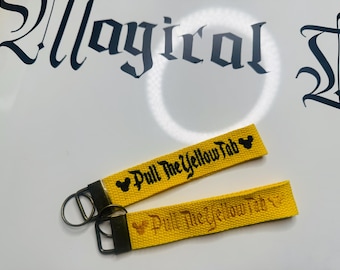 Pull the Yellow Tab keychain: Disney park’s inspired keychain