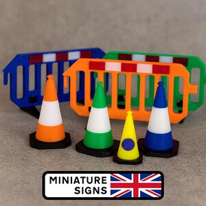May include: A collection of miniature road signs and traffic cones in vibrant colours. The cones are orange, green, yellow, and blue with white stripes. Blue and orange barricades are also present. The text "MINIATURE SIGNS" is displayed with a UK flag.