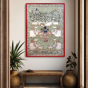 May include: An ornate, framed painting with a red border. The artwork depicts a blue figure playing a flute, surrounded by white cows and figures on a light green background. The painting is displayed above a wooden bench, flanked by potted plants.