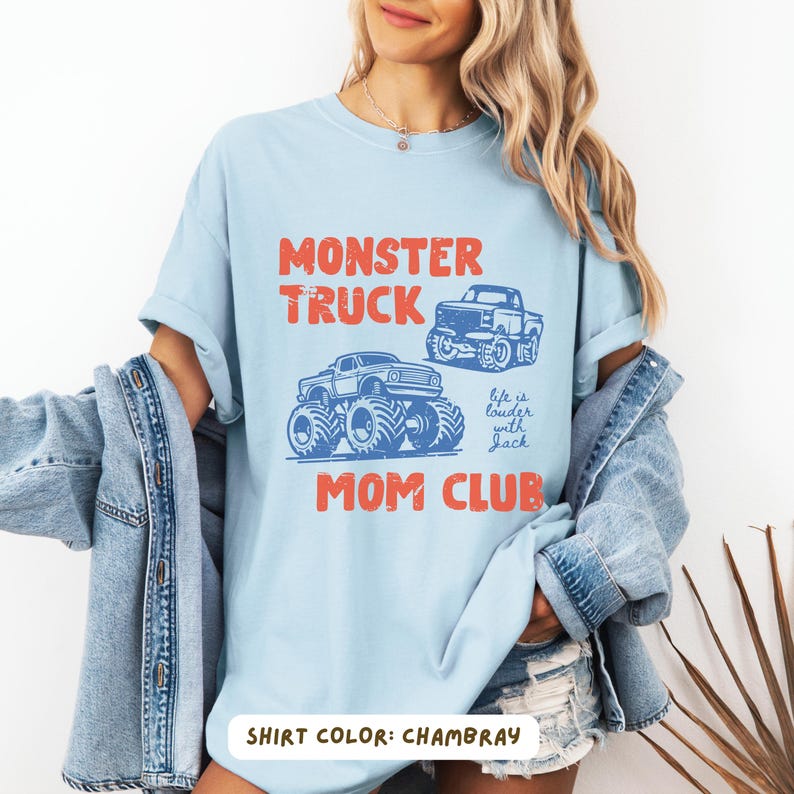 Monster truck themed mom t-shirt featuring bold red text and blue vintage trucks graphic, designed for mothers of boys with a racing-inspired aesthetic