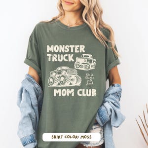 Monster truck themed mom t-shirt featuring bold red text and blue vintage trucks graphic, designed for mothers of boys with a racing-inspired aesthetic
