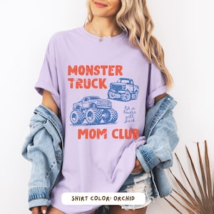 Monster truck themed mom t-shirt featuring bold red text and blue vintage trucks graphic, designed for mothers of boys with a racing-inspired aesthetic