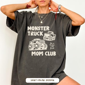 Monster truck themed mom t-shirt featuring bold red text and blue vintage trucks graphic, designed for mothers of boys with a racing-inspired aesthetic