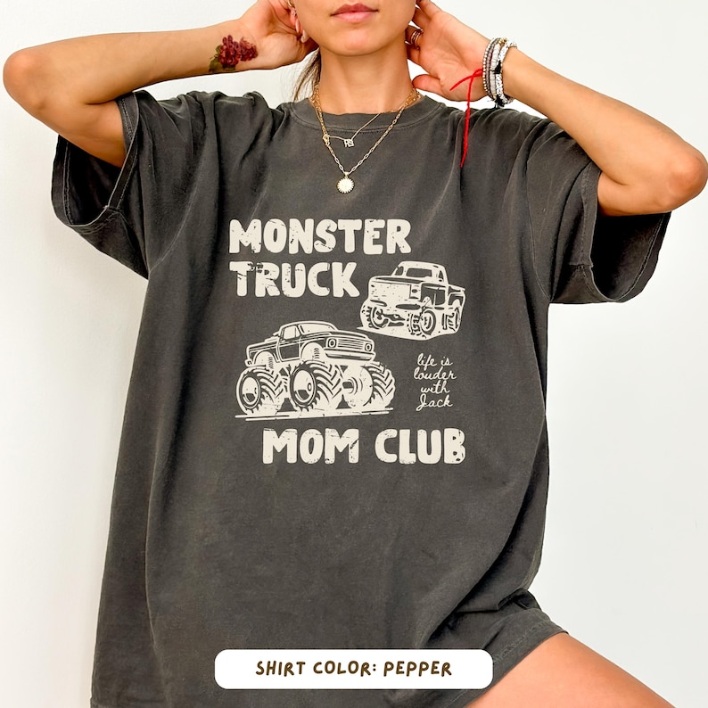 Monster truck themed mom t-shirt featuring bold red text and blue vintage trucks graphic, designed for mothers of boys with a racing-inspired aesthetic