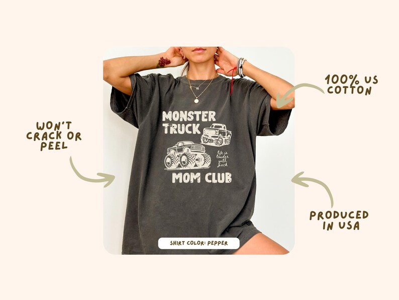 May include: Dark gray t-shirt with a graphic that reads "MONSTER TRUCK MOM CLUB". The design features two monster truck illustrations. The shirt is made of 100% US cotton and is produced in the USA. The shirt color is pepper.