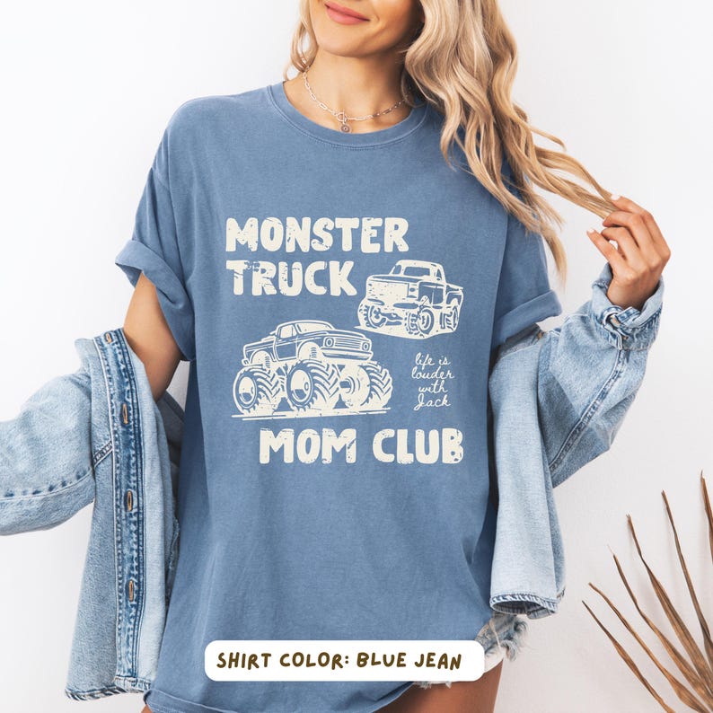 Monster truck themed mom t-shirt featuring bold red text and blue vintage trucks graphic, designed for mothers of boys with a racing-inspired aesthetic