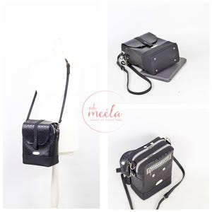 May include: Three black leather crossbody bags with silver hardware. The bags have different designs and zipper closures. The bags are on a white background.