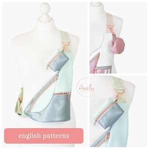 May include: A teal and light blue crossbody bag with a zippered pocket and a small, matching teal pouch. The bag is worn on a mannequin with a rose gold chain strap. The bag is labeled "oh meela" and "english patterns".