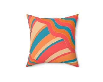 May include: Square throw pillow with a vibrant, retro-inspired design. The pillow features a repeating pattern of curved lines and stripes in shades of coral, orange, teal, and beige. The pillow is a square shape.