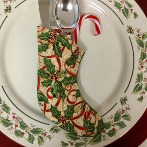 Christmas Sock Silverware Holder in a Holly Print with a Red Ribbon on Cream background image 2