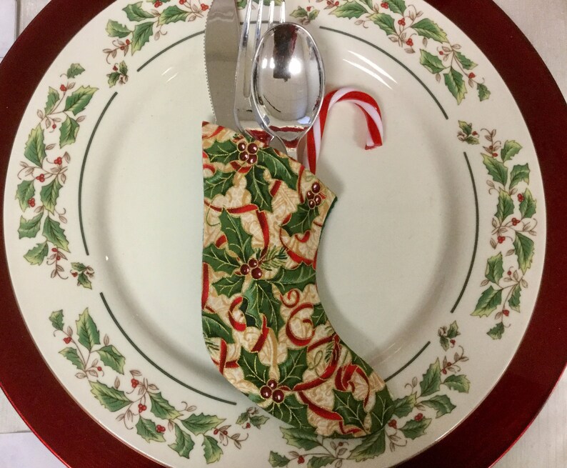 Christmas Sock Silverware Holder in a Holly Print with a Red Ribbon on Cream background image 2