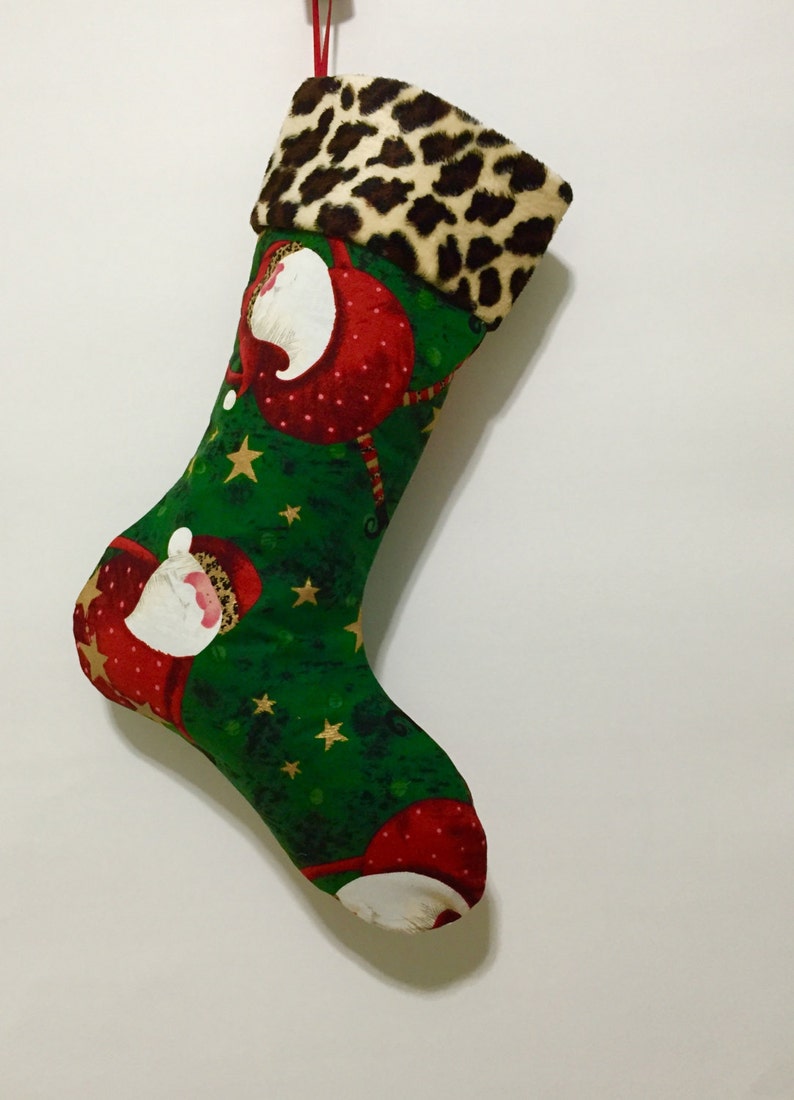 Whimsical Santa wearing Faux fur hats on Green Background with Faux Cheetah fur Cuff