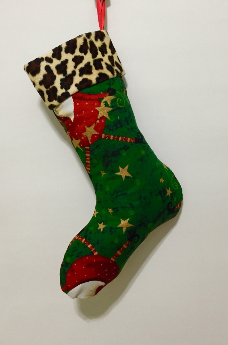Whimsical Santa wearing Faux fur hats on Green Background with Faux Cheetah fur Cuff